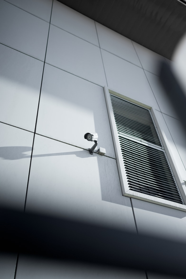 A security camera mounted in a bright facility.