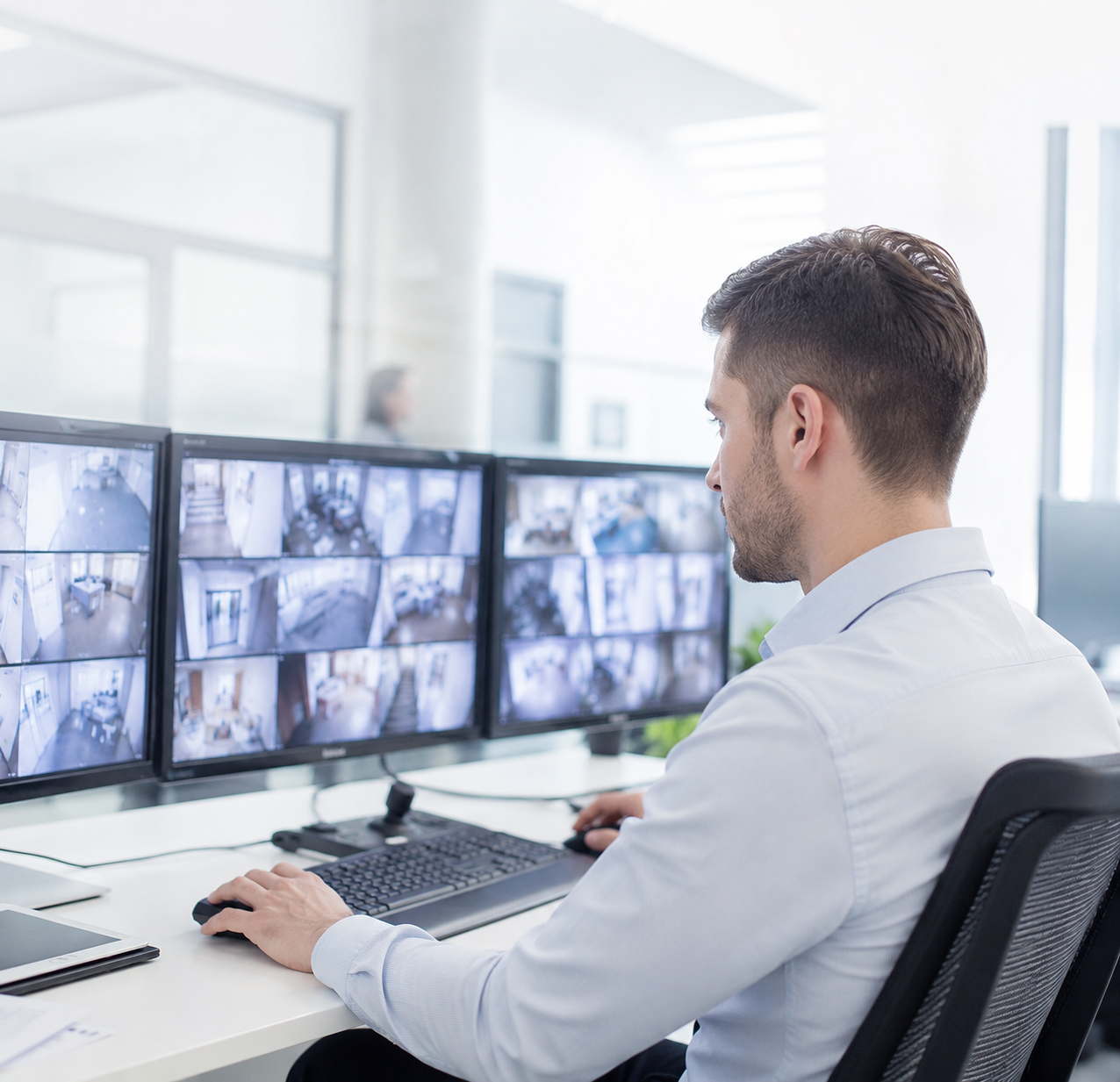 An operator monitoring a wall of security feeds.